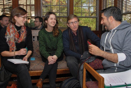 A group composed by two women and two men talking during a workshop