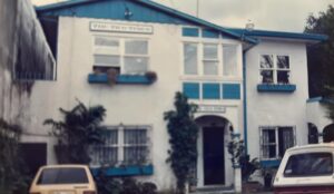 White two-story building with blue trim