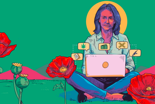 Woman on computer in a field of poppies